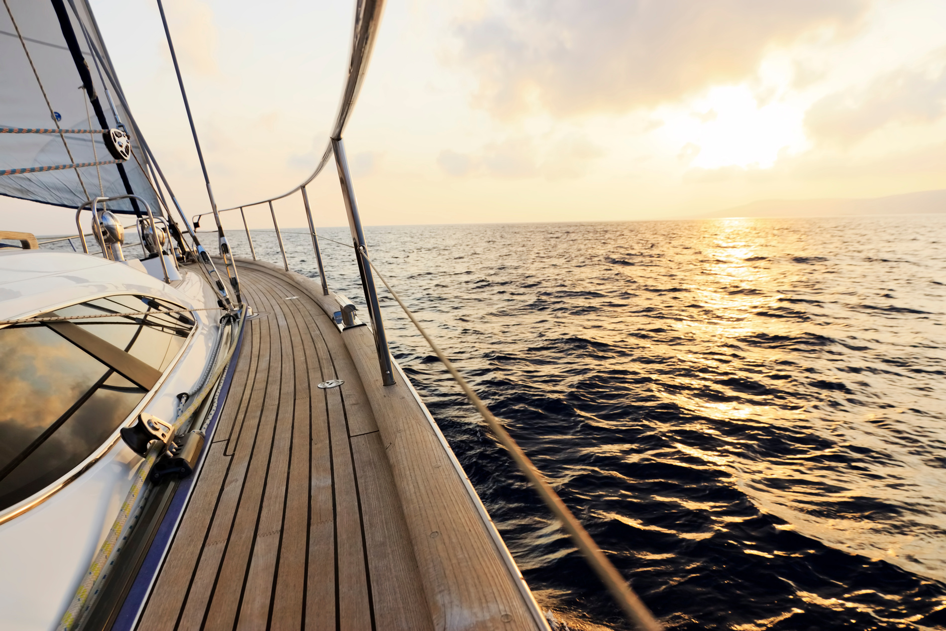 Luxury yacht sailing at sunset